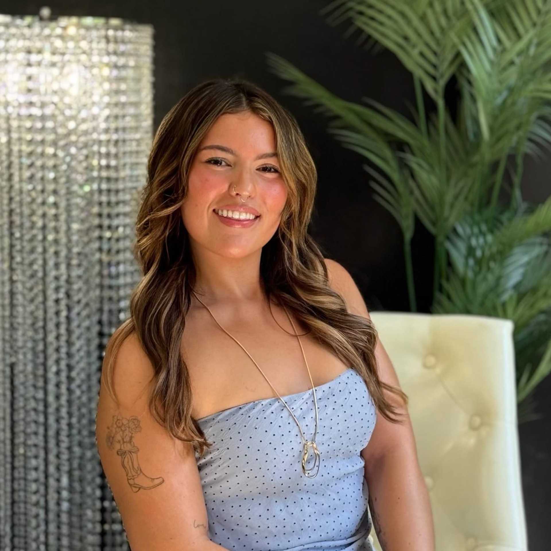 Portrait of Bella, a professional stylist at New Era Salon, showcasing their expertise and style.